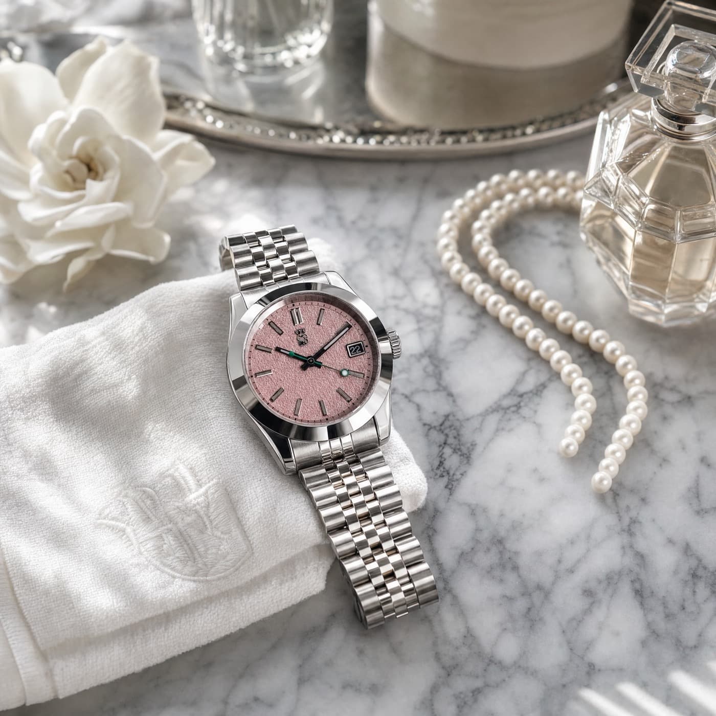 Watch staged on marble vanity with pearls